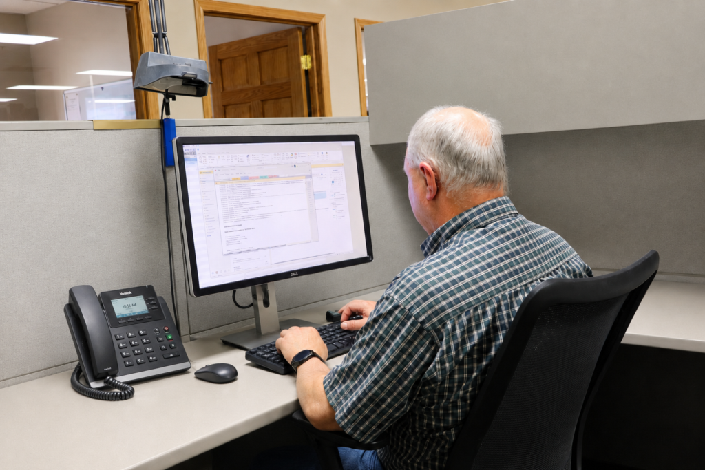 Senior Design Engineer Jim Myers Working at his desk at Deco Products